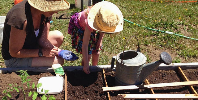 child and mother planting